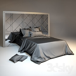 Bed Silk bedding and headboard with mirror tiles in a silver frame 