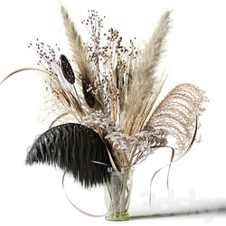 Bouquet of dried flowers with a black feather in a glass vase 