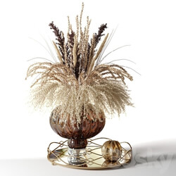 A bouquet of dried flowers in a pot bellied brown vase on a tray 