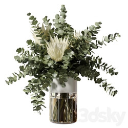 Bouquet with three white proteas and eucalyptus branches in a glass vase 