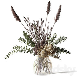 Bouquet with eucalyptus bankxias and tall grass in a glass vase 