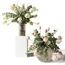 Bouquets of eucalyptus and tulips in glass vases 