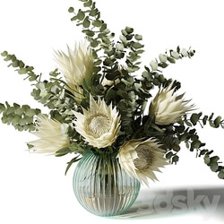 Bouquet with white proteas and eucalyptus in a ribbed glass vase 