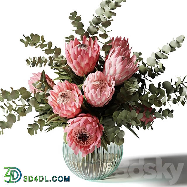 Bouquet with pink proteas and eucalyptus in a ribbed glass vase